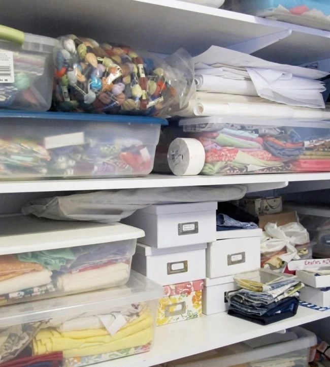 Shelves holding organised samples and embroidery materials